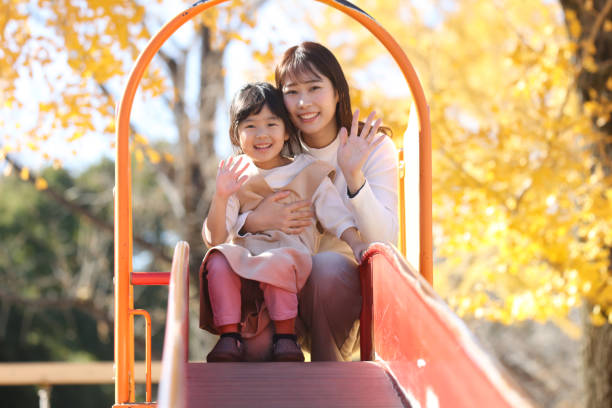 istock Parent and child playing on the slide 1948554392