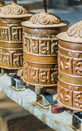 Sanskrit inscriptions on brass Buddhist prayer wheels, Kathmandu, Nepal
