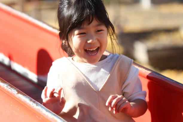istock girl playing on the slide 1948554906