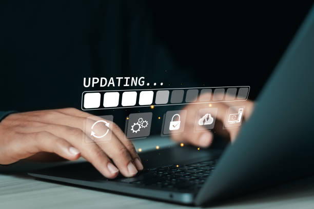 istock User use laptop with updating progress bar on virtual screen for Update the operating system with new versions and improve software updates. 1948561029