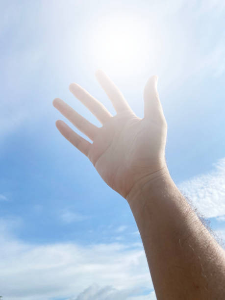 istock close up of man hand with blue sky 1948562062