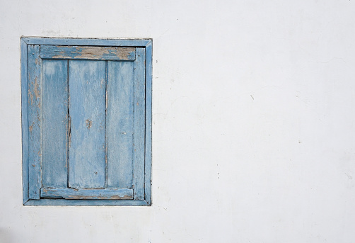 blue painted window in the old wall.