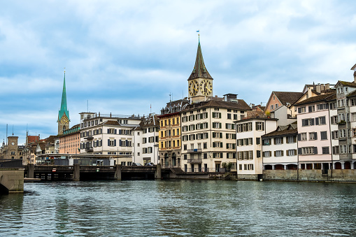 Zurich city center, Switzerland. Zuerich old town with famous Fraumunster and St. Peter Church on bank of river Limmat in winter.