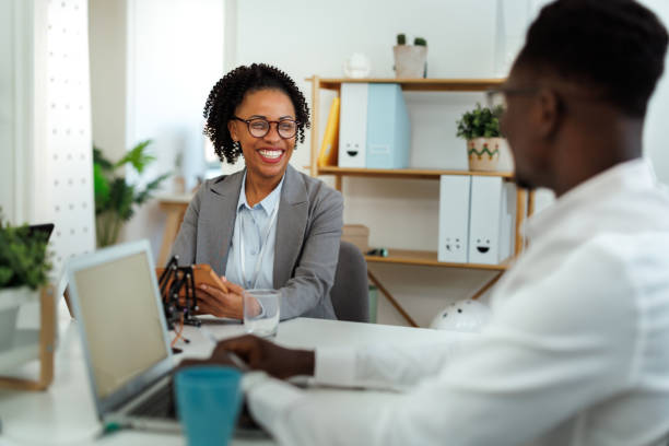 istock Two smiling colleagues working together at the office 1948600208