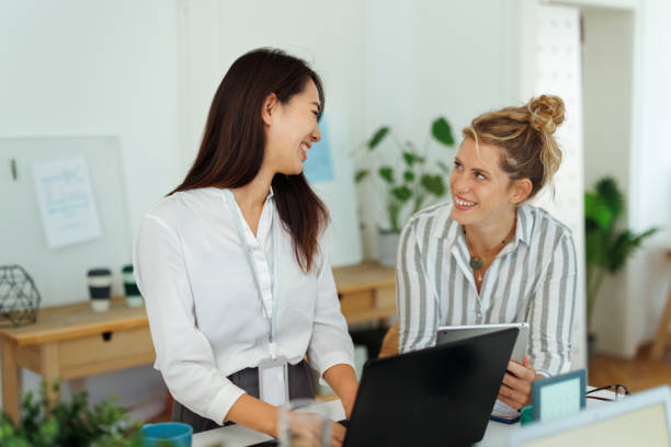 istock Well dressed female colleagues cooperating at modern office 1948600280