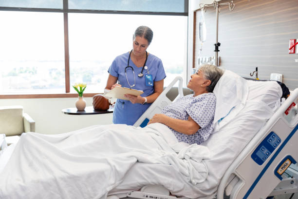 istock Female surgeon documents information about female senior patient 1948600501