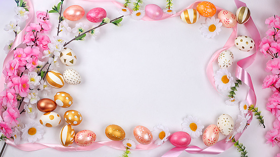 Abstract Easter composition,spring banner with sakura flowers and painted eggs with place for text,Easter holidays concept,greeting card,selective focus