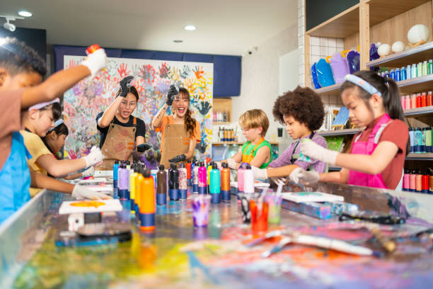 istock Group of Diversity school children learning acrylic art together in art class. 1948753638