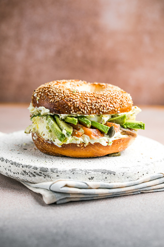 Hearty Breakfast Sandwich on a Bagel with avocado, salmon, egg