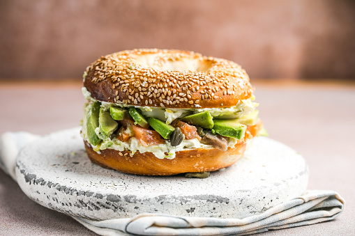 Hearty Breakfast Sandwich on a Bagel with avocado, salmon, egg