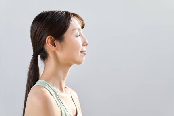 istock woman meditating with eyes closed 1948763549