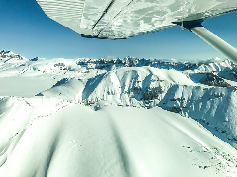 The beauty of Alaska as seen from above. Picture of Alaska's Wrangle mountains, with glacial flows and stunning landscapes, from the window of a small airplane. The airplane was flying over the Wrangle Mountains in Interior Alaska.
