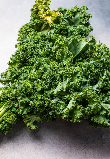 istock Bunch of fresh kale over a concrete background. Overhead view. 1948770252