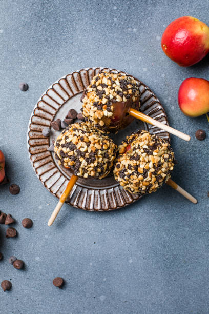 istock delicious carmel candy apples with covered in chopped nuts 1948770275