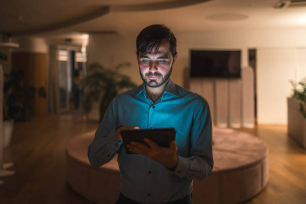 istock Professional Male Working on Tablet at Night in Office 1948833964