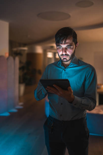 istock Hispanic Male Professional Working on Tablet at Night 1948833965