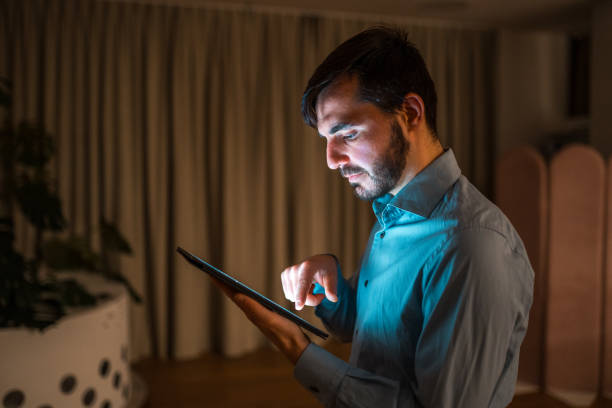 istock Caucasian Male Professional Working on Tablet at Night Indoors 1948833971