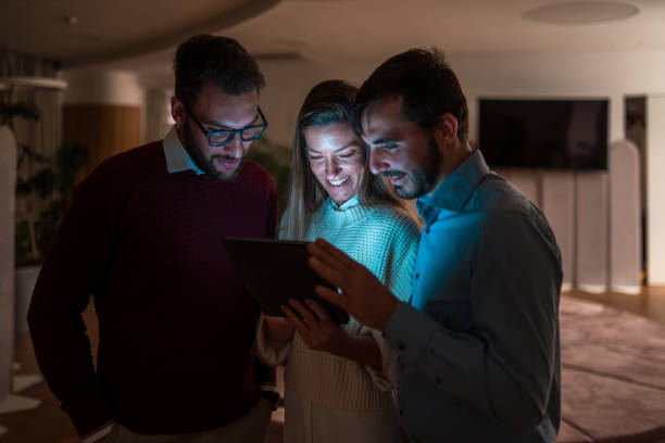 istock Diverse Team of Professionals Working Late Using Tablet 1948833974