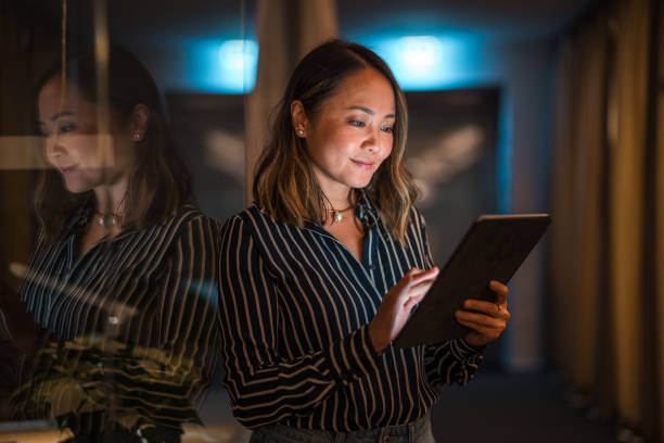 istock Asian Female Professional Working on Tablet at Night 1948834495