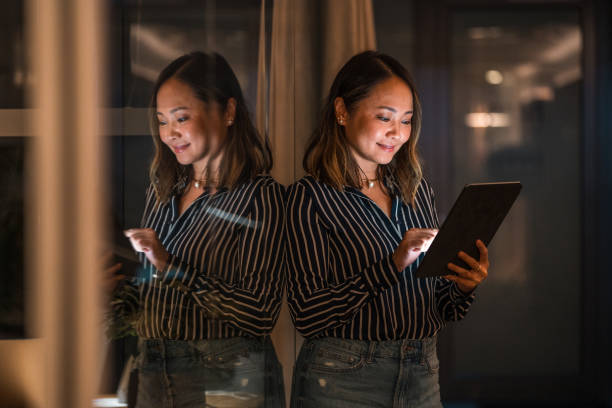 istock Asian Female Professional Working on Tablet at Night 1948834500