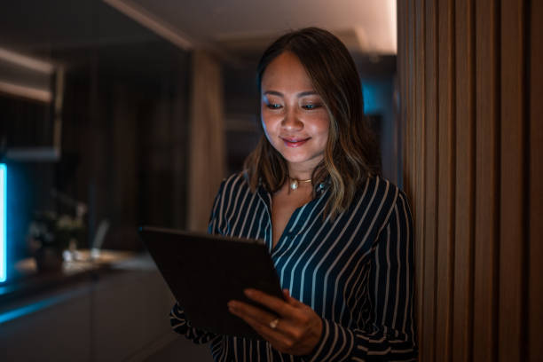 istock Asian Female Professional Working on Tablet at Night 1948834502