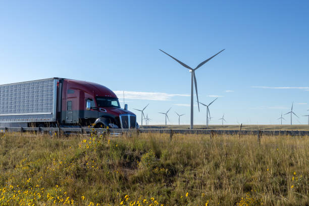 istock Truck Passing Wind Turbines on Rural Highway 1948888370
