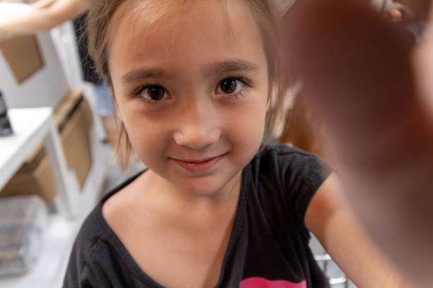 Smiling Young Girl Taking a Selfie at Home