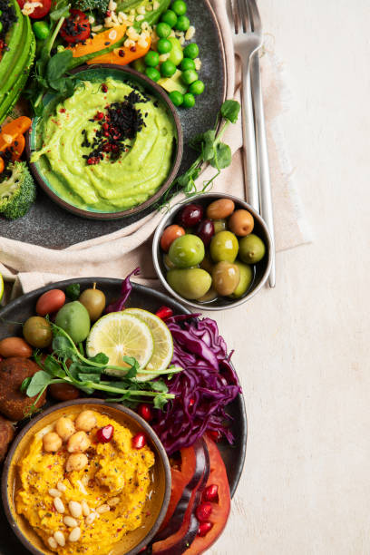 istock Vegan tasty hummus, herb hummus, beetroot hummus on a light wood background. 1948896950