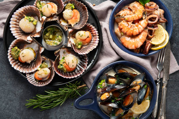 istock Fried scallops with butter and green sauce served in seashells. 1948925583