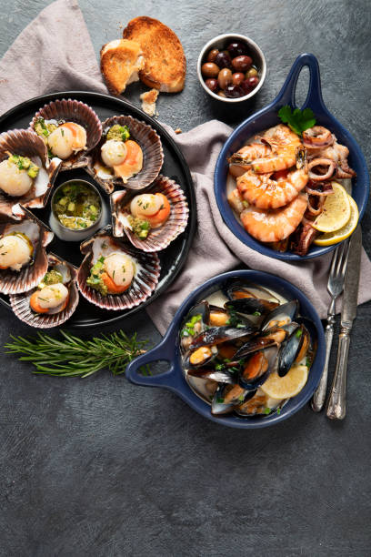 istock Fried scallops with butter and green sauce served in seashells. 1948925586