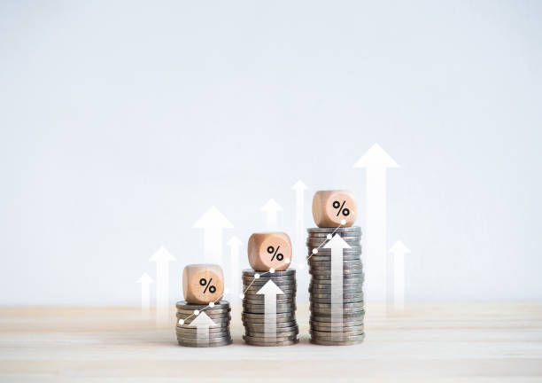 istock Percentage icon on wooden cube blocks on coin stacked bar graph chart steps with rising arrows on white background. Investment, profit, income, sales, business growth, economic improvement concept. 1948938726