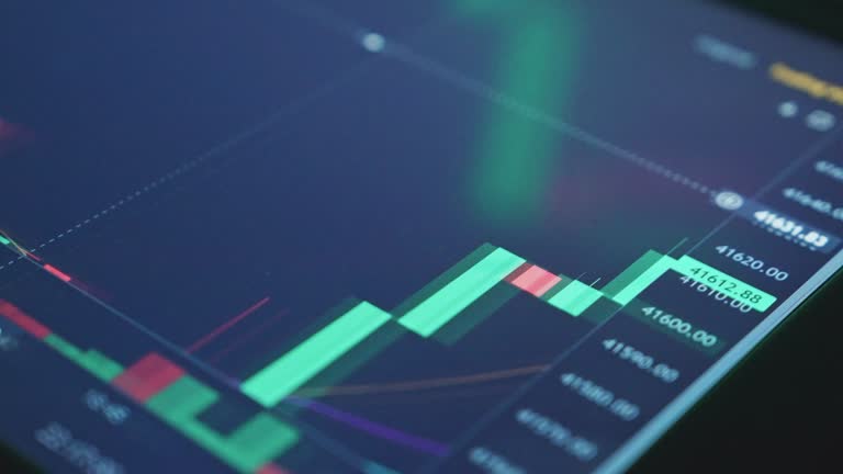 Moving financial chart with downtrend line candlestick graph and numbers in stock market on black color monitor