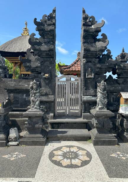 istock a stone building with statues, likely a temple in Bali 1949031487