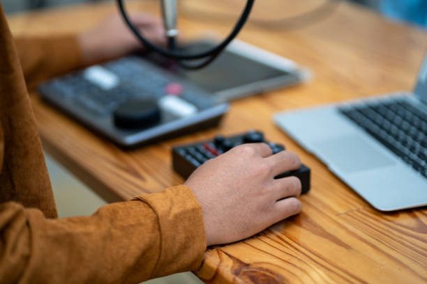 istock Code-up image of a young man wearing headphones recording a podcast in a studio. 1949035341