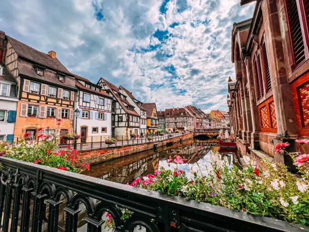 Vibrant colored Alsatian half-timbered french houses on the side of river Lauch in Petite Venise, Colmar, France