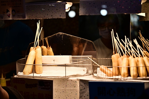 Hualien, Taiwan - Aug 17, 2023: Corn do stall in the night market. Corn dog is one of the popular food in Taiwan night market.