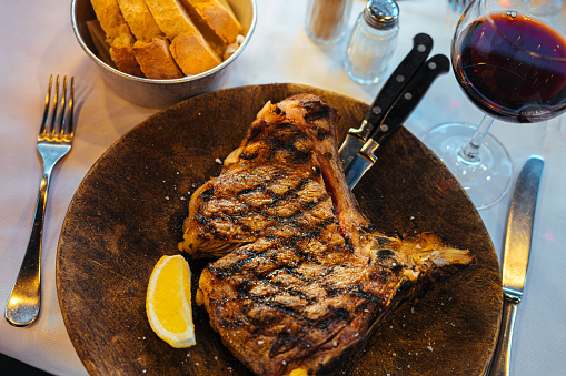 Close-Up Florentine T-Bone Steak and Lemon Wedge in Florence, Italy
