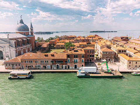 An Elevated View of a Crane Unloading a Shipment of Goods from a Semi Truck on a Ferry at Giudecca, Venice Italy