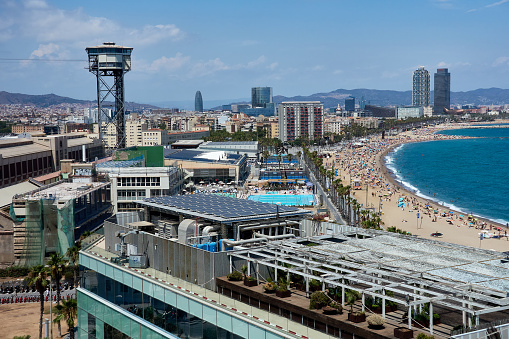 Barceloneta beach and the Barcelona cable car tower on a summer afternoon.