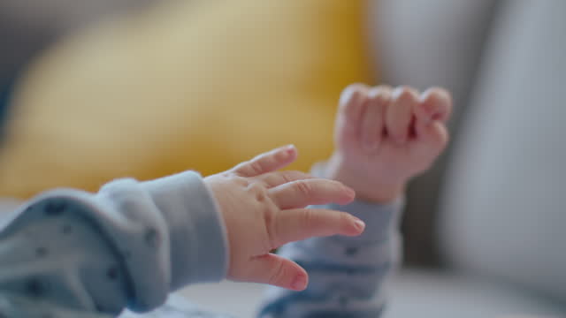 SLO MO Handheld Shot of Baby Boy's Hands on Sofa at Home