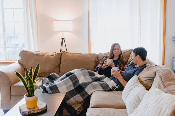 istock Multi Racial Couple Relaxing at Home Together 1949127709