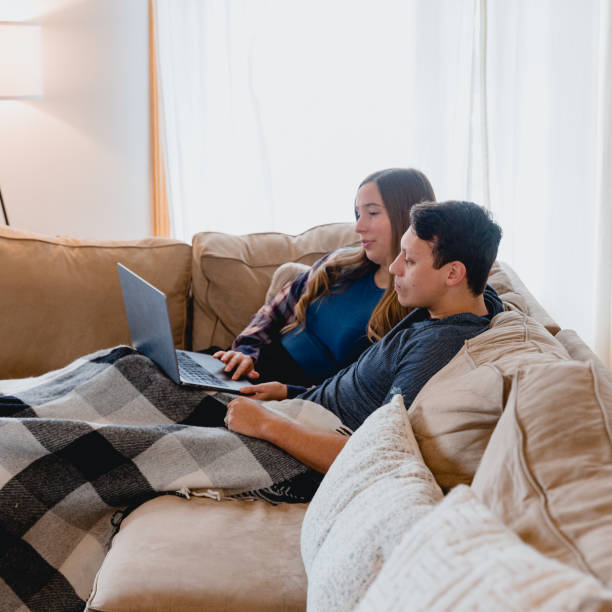 istock Multi Racial Couple Using Laptop at Home Together 1949127711