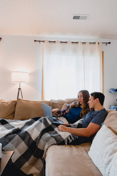 istock Multi Racial Couple Using Laptop at Home Together 1949127728