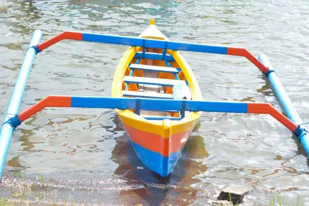 Close-Up View Of The Recreational Paddleboat, Tethered And Floating Along The Edge Of The Mountain Lake