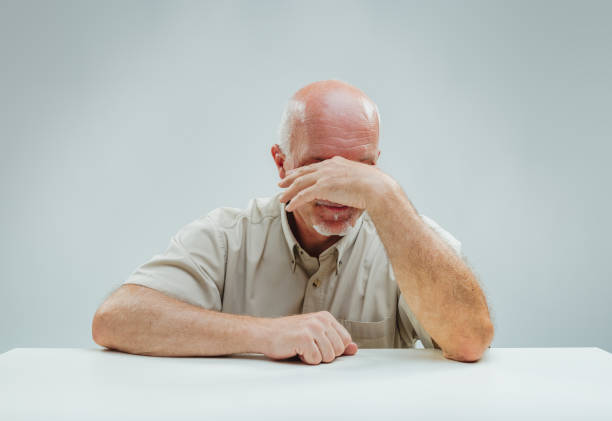 istock Tired eyes peek above hand, showing fatigue 1949167513