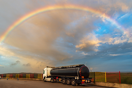 Tanker truck with dangerous goods parked under a spectacular sky.