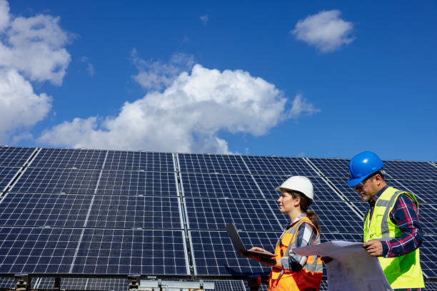 istock Solar panel and engineer workers working on a farm on clean electricity. 1949175858