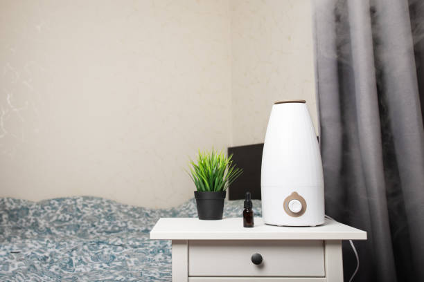 istock Aromatherapy in the bedroom, ultrasonic air diffuser on the table, adding a subtle aroma to the air 1949178485