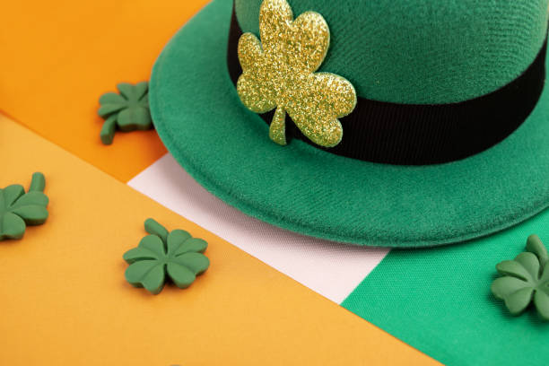 istock green irish leprechaun hat with shamrocks and irish flag on orange background, saint patrick day background, irish holiday card 1949178501