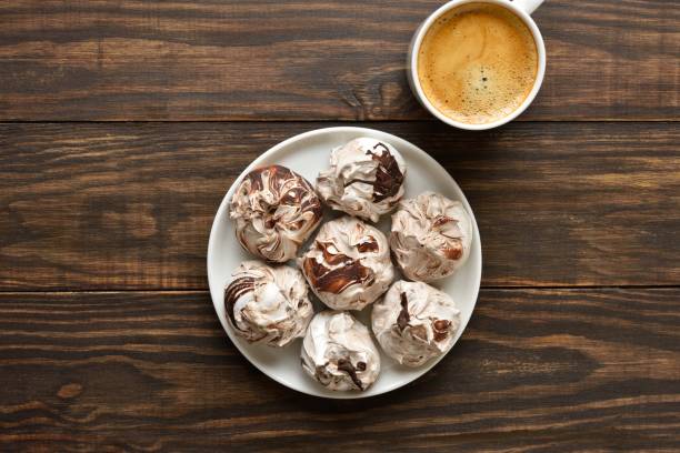 istock Chocolate meringue cookies and cup of coffee 1949186313